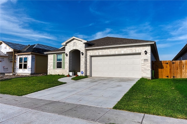 2634 Westeros St, Corpus Christi, TX 78415 - view of front facade with an attached garage, driveway, and brick siding
