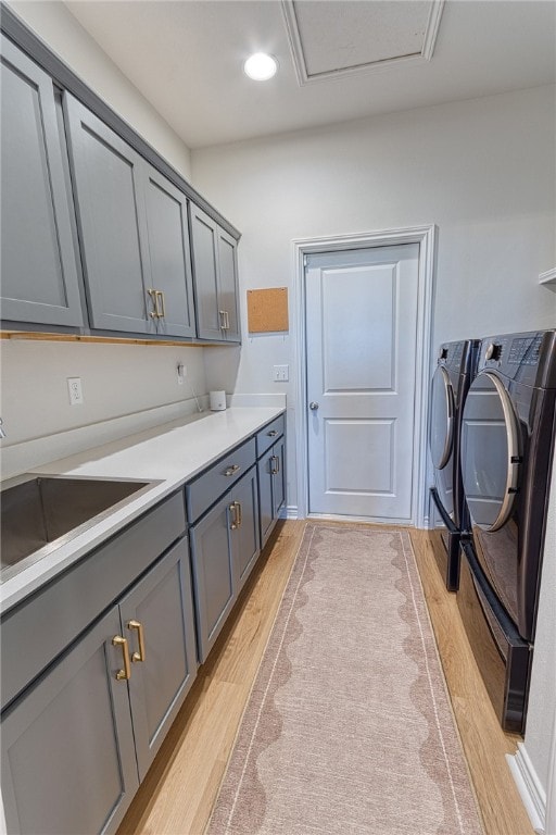 2634 Westeros St, Corpus Christi, TX 78415 - laundry area featuring cabinet space, washing machine and clothes dryer, and light wood-style floors