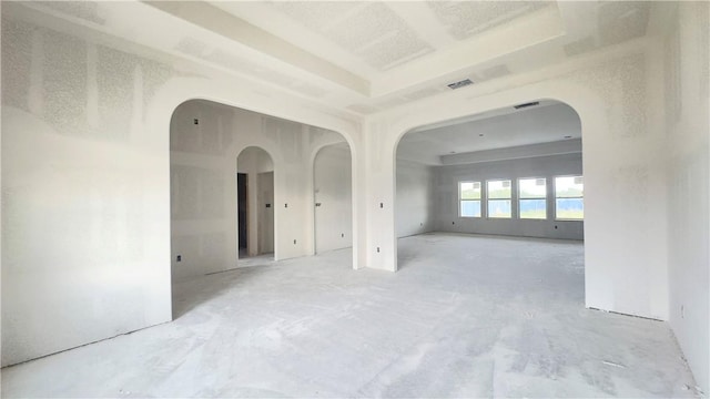 empty room with arched walkways and visible vents