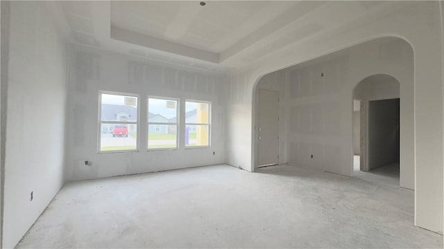 unfurnished room featuring arched walkways