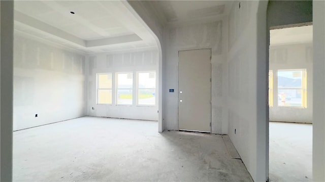 spare room with a wealth of natural light and arched walkways