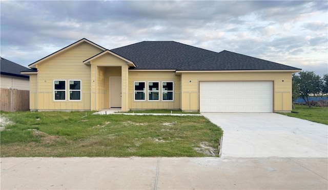 ranch-style house with a front lawn, driveway, an attached garage, and fence