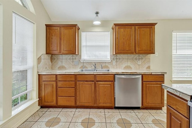 1225 Calle, San Carlos, Corpus Christi, TX 78417 - kitchen featuring stainless steel dishwasher, backsplash, brown cabinets, and light tile patterned floors