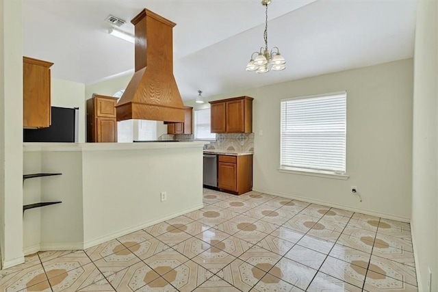 1225 Calle, San Carlos, Corpus Christi, TX 78417 - kitchen with stainless steel dishwasher, a chandelier, fridge, brown cabinetry, and tasteful backsplash