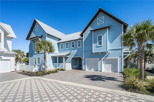 view of front of house with a garage, decorative driveway, and metal roof