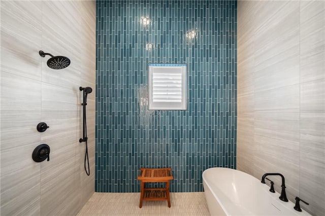 bathroom with a freestanding tub, a tile shower, tile walls, and tile patterned floors