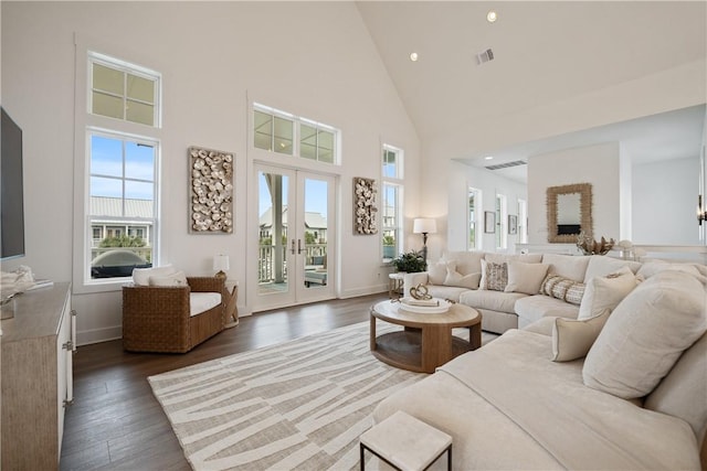 living room featuring high vaulted ceiling, dark wood-style flooring, visible vents, baseboards, and french doors