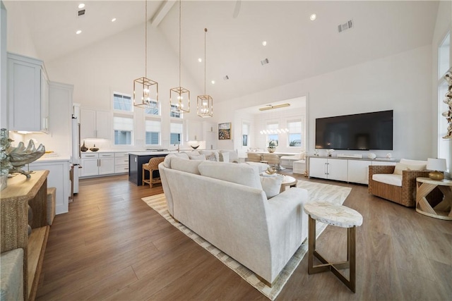 living room with visible vents, wood finished floors, beamed ceiling, high vaulted ceiling, and recessed lighting