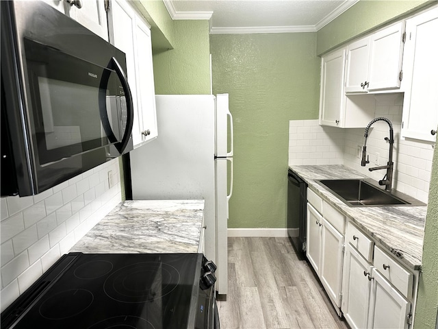 kitchen featuring white cabinetry, black appliances, sink, and backsplash