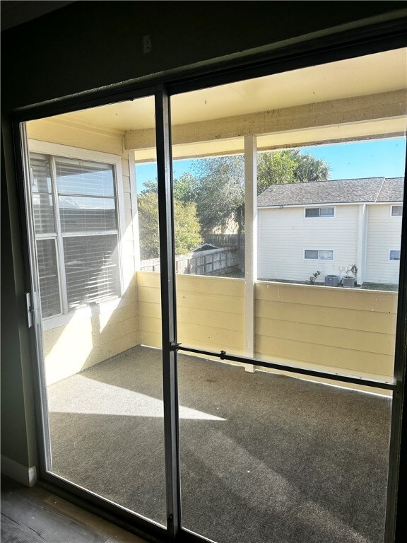 doorway to outside with a wealth of natural light and carpet