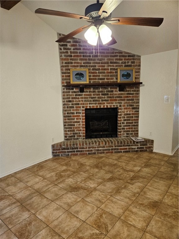 unfurnished living room with lofted ceiling, ceiling fan, and a fireplace