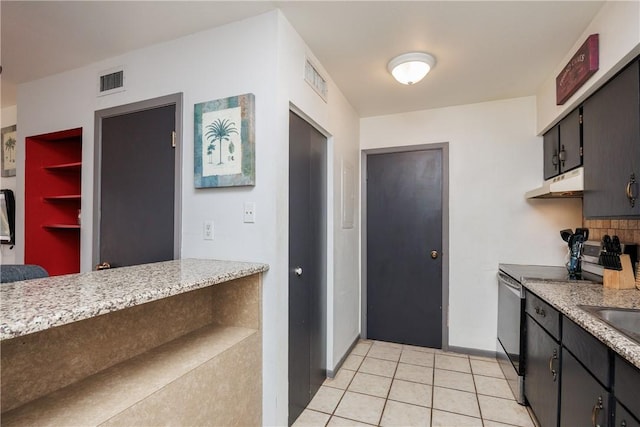 kitchen with stainless steel electric stove, tasteful backsplash, and light tile patterned floors