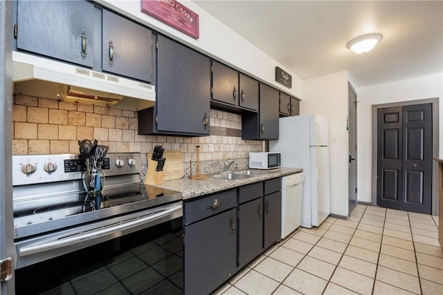 kitchen featuring sink, white appliances, light tile patterned flooring, and tasteful backsplash