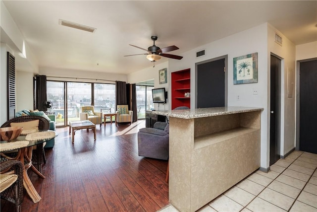 kitchen with ceiling fan and light hardwood / wood-style flooring