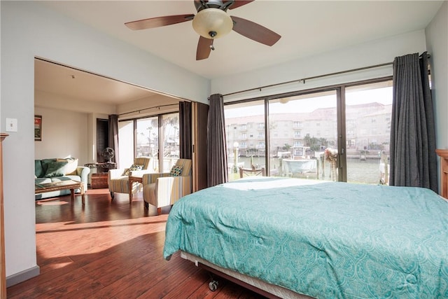 bedroom with ceiling fan, hardwood / wood-style flooring, and a water view