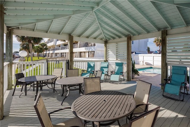 deck featuring a gazebo and a fenced in pool