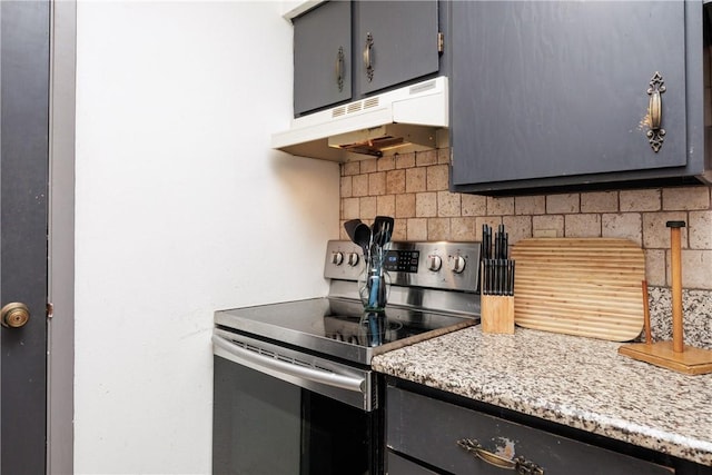 kitchen featuring stainless steel range with electric cooktop, decorative backsplash, and light stone countertops