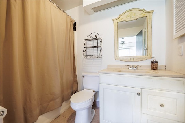 bathroom with toilet, tile patterned floors, and vanity