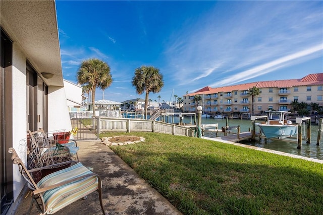 view of yard with a dock and a water view