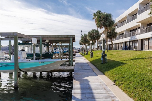 view of dock featuring a yard and a water view