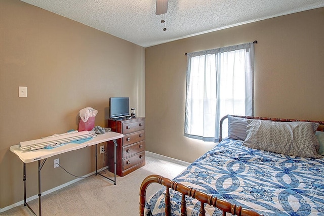 bedroom with a textured ceiling, light carpet, multiple windows, and ceiling fan