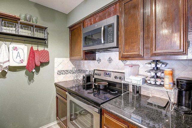 kitchen with appliances with stainless steel finishes and decorative backsplash