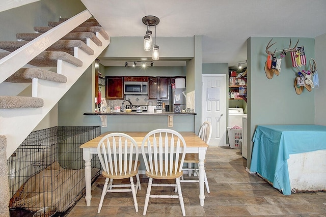 dining room with light wood-type flooring and sink