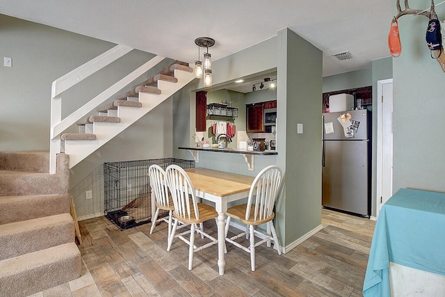 dining room with hardwood / wood-style flooring