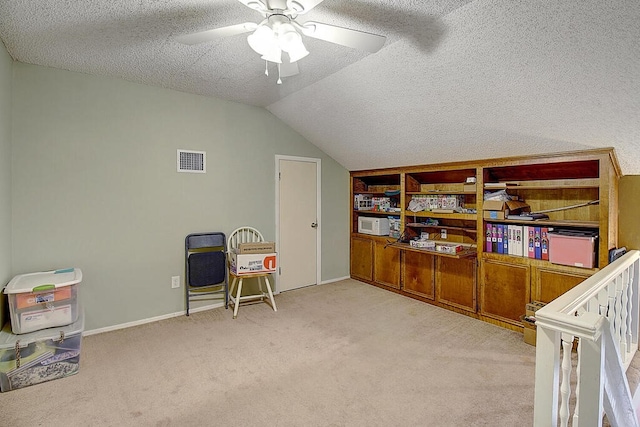 interior space featuring ceiling fan, light colored carpet, a textured ceiling, and lofted ceiling