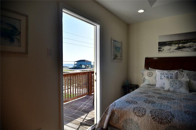 bedroom featuring a water view, access to outside, multiple windows, and recessed lighting