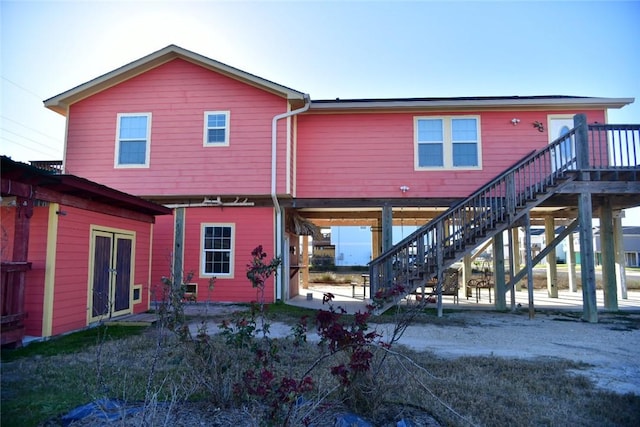 rear view of property with stairs