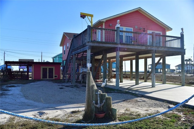 exterior space with stairway and a wooden deck