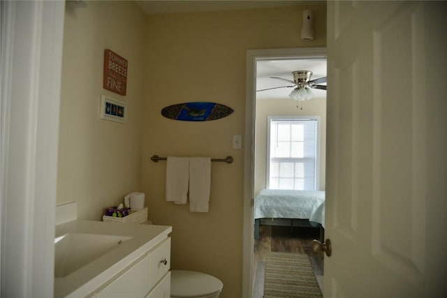 bathroom featuring ceiling fan, vanity, toilet, and wood finished floors