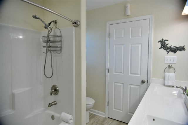 full bath featuring toilet, double vanity, a sink, and bathing tub / shower combination