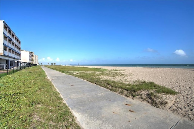 view of home's community featuring a water view and a beach view