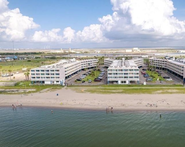 birds eye view of property with a beach view and a water view