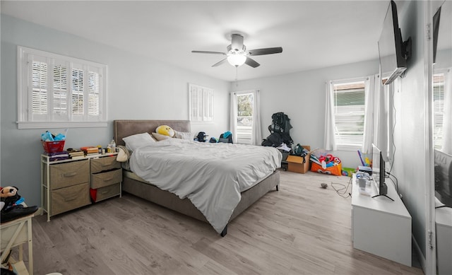 bedroom with ceiling fan and light hardwood / wood-style floors