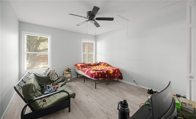 living area featuring light hardwood / wood-style flooring and ceiling fan