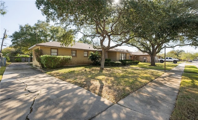 ranch-style house featuring a front lawn