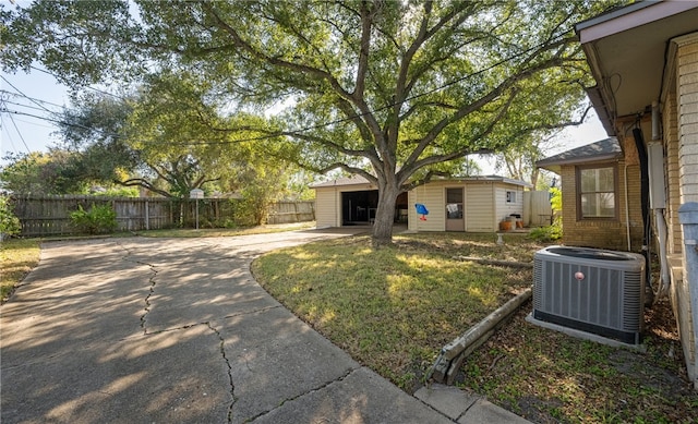 view of yard with an outbuilding and central AC unit