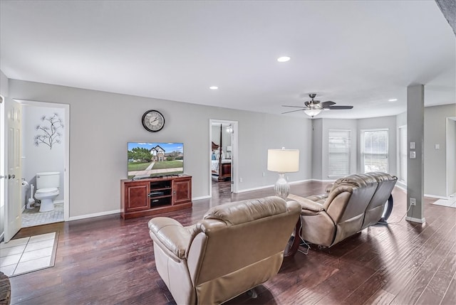 living room featuring dark hardwood / wood-style floors and ceiling fan