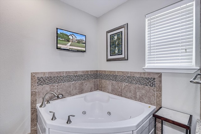 bathroom featuring a washtub, tile walls, and a wealth of natural light