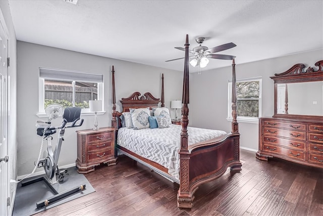 bedroom featuring multiple windows, ceiling fan, and dark wood-type flooring