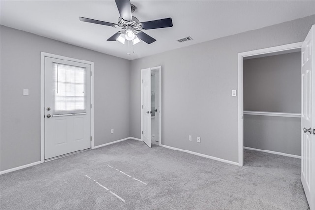 carpeted spare room featuring ceiling fan