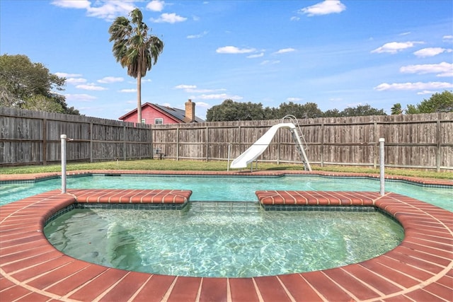 view of pool with an in ground hot tub and a water slide