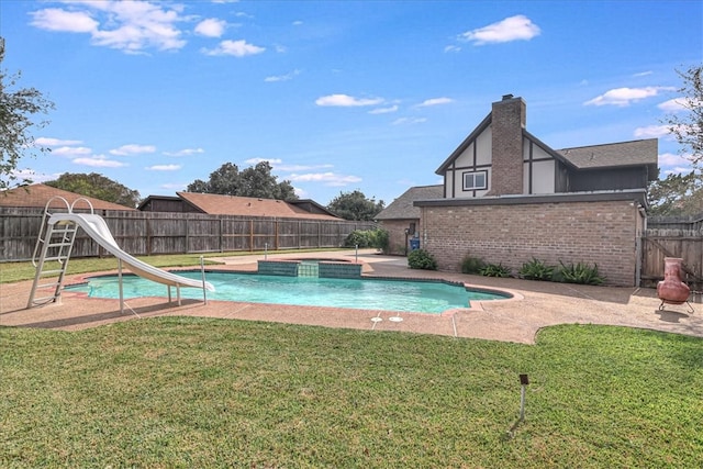 view of pool featuring a yard and a water slide