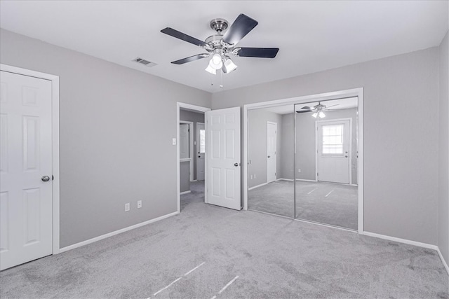 unfurnished bedroom featuring ceiling fan and light colored carpet