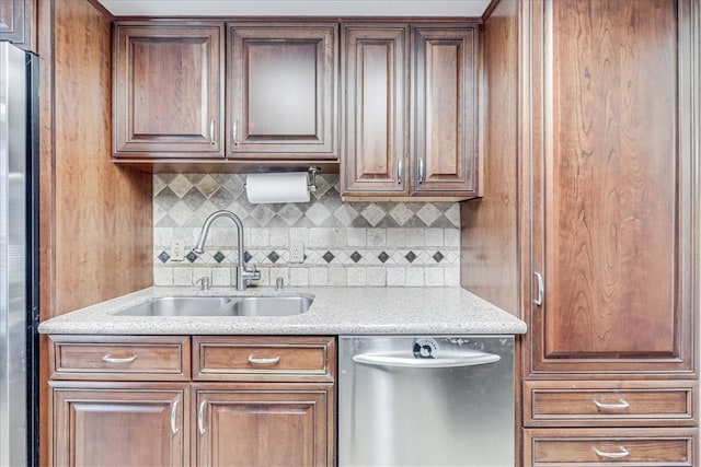 kitchen with backsplash, stainless steel appliances, and sink