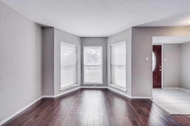 unfurnished room with wood-type flooring