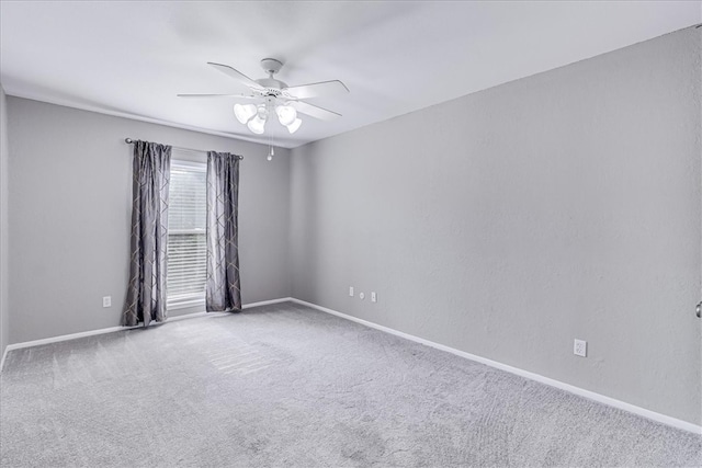 unfurnished room with carpet flooring and ceiling fan